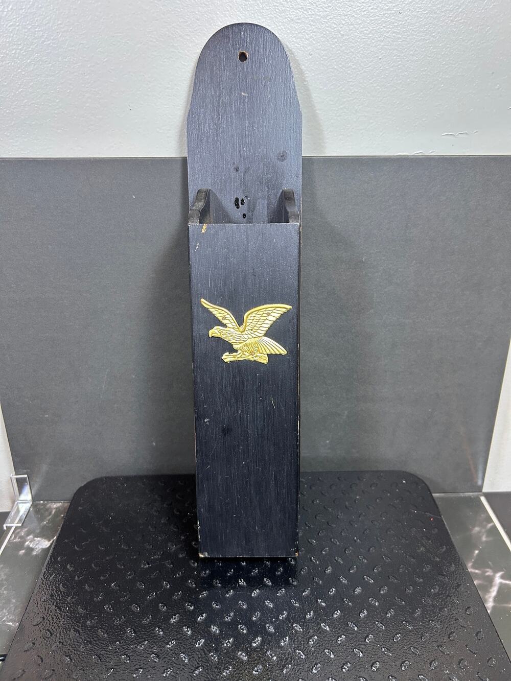 vintage wall-mounted wood match holder with gold colored metal eagle emblem